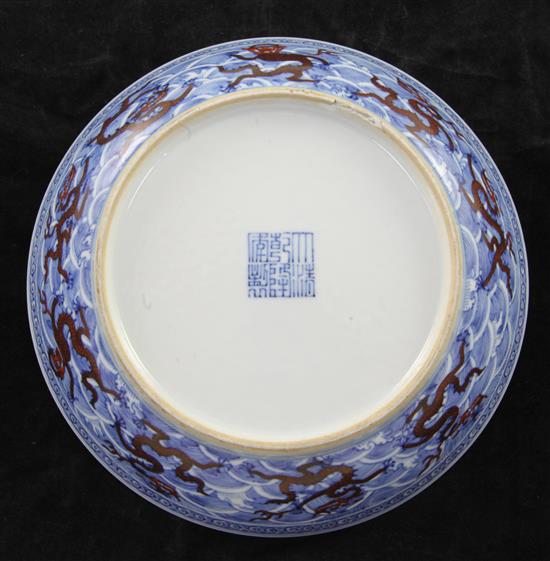 A Chinese iron red and underglaze blue dragon dish, Qianlong seal mark and of the period (1736-95), diameter 17.5cm, slight faults